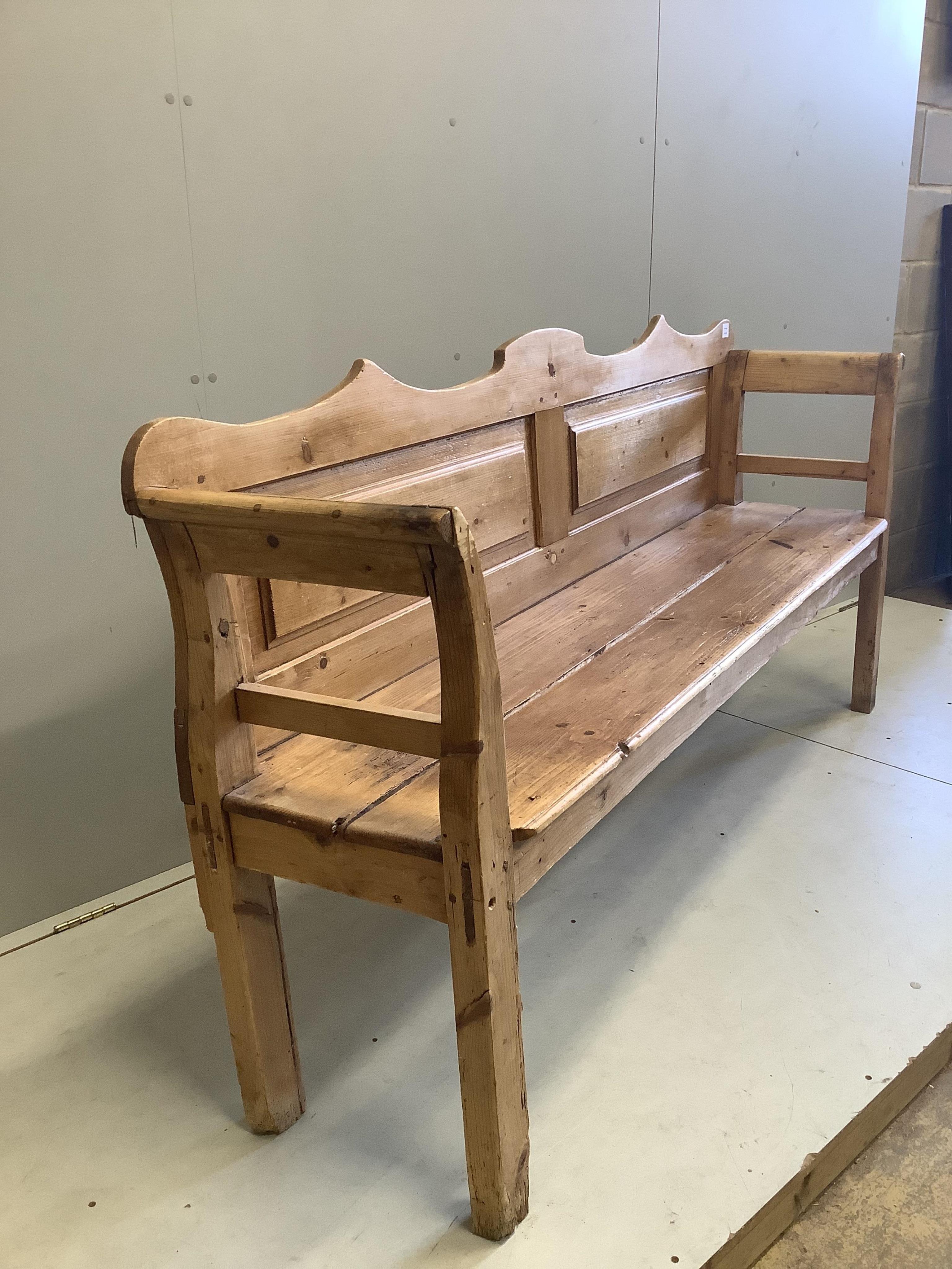 A 19th century pine settle, width 196cm, depth 44cm, height 97cm
